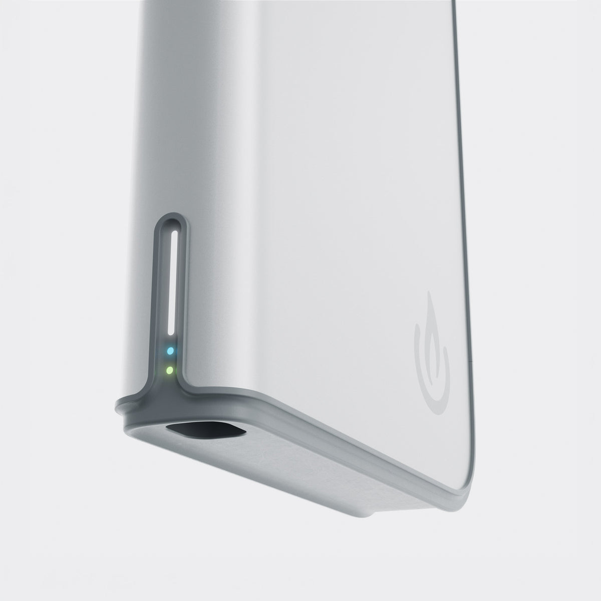 A close-up of a slim rectangular electronic device in a metallic silver finish, showing a vertical slot with two small indicator lights and a subtle power symbol on the side, set against a light gray background. The device is the Backup Core Fridge Battery Backup System.