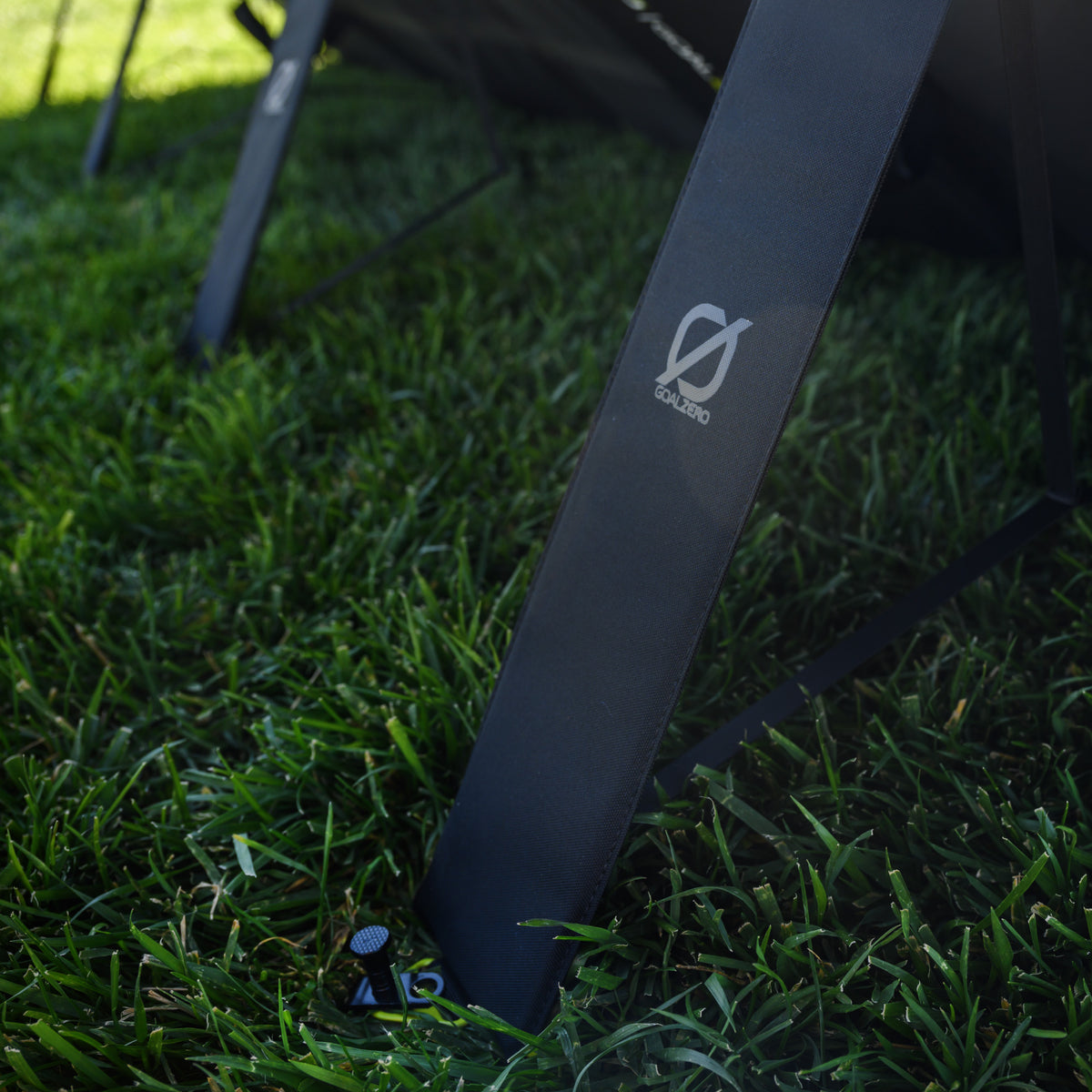 Back of a Nomad 400w solar panel showing the 4 retractable standing feet that support it.